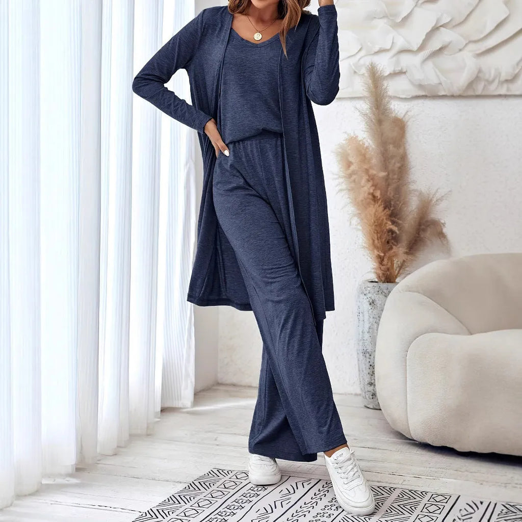 Blue women's three-piece suit featuring cardigan trousers, a long-sleeve top, and suspenders on a hanger.