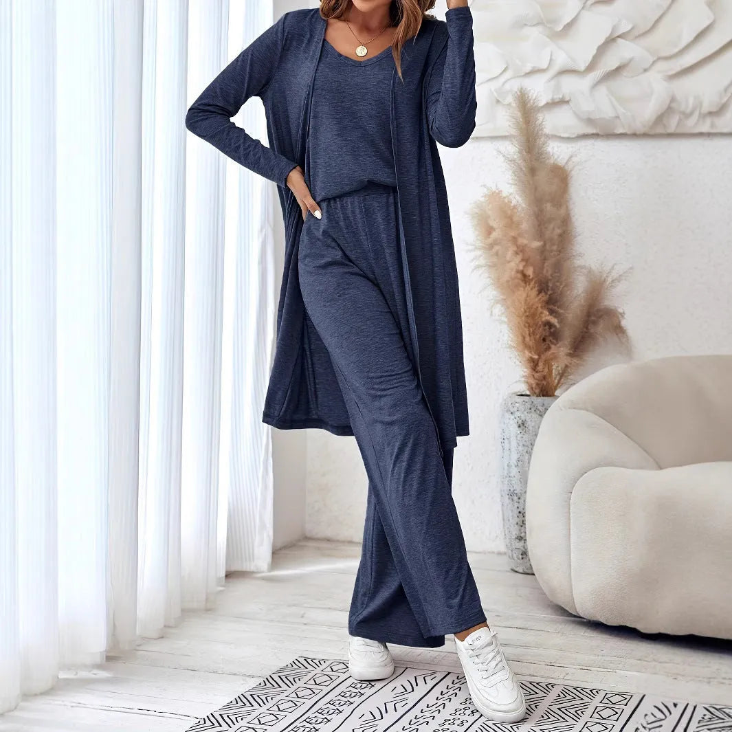 Blue women's three-piece suit featuring cardigan trousers, a long-sleeve top, and suspenders on a hanger.