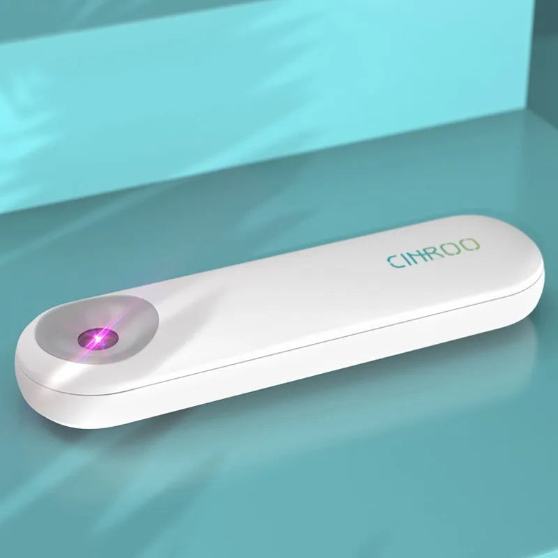 White portable UV sterilizer lamp for disinfecting mobile phones and small items.