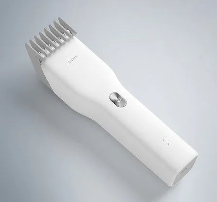 Black and white cordless electric hair clippers with adjustable comb on a stand
