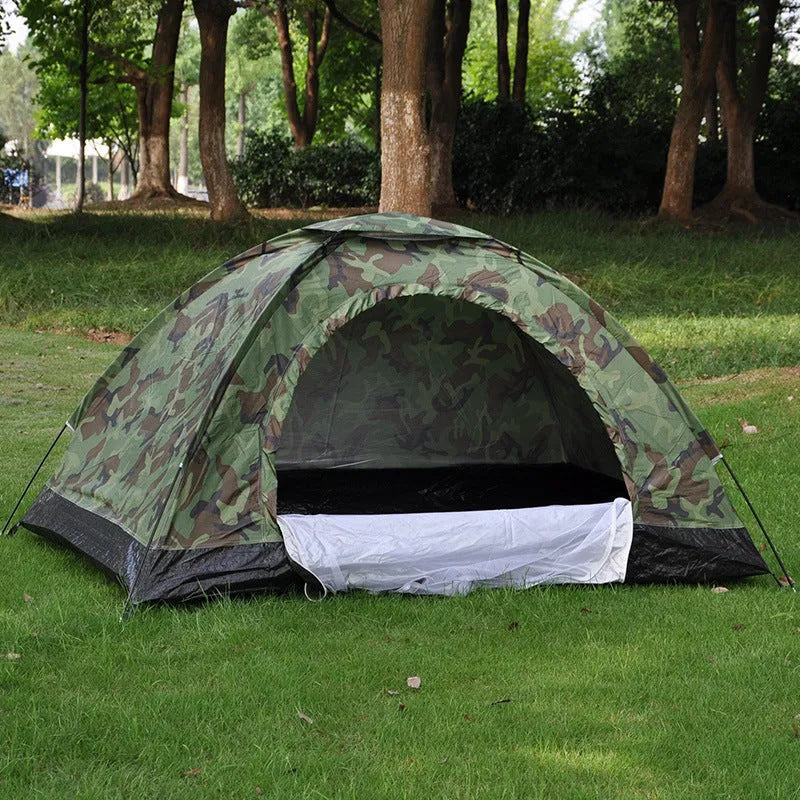 Double camouflage pattern tent pitched outdoors with triangular skylight visible