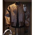 Man wearing a black slim-fit extended length PU leather jacket with a litchi pattern texture.