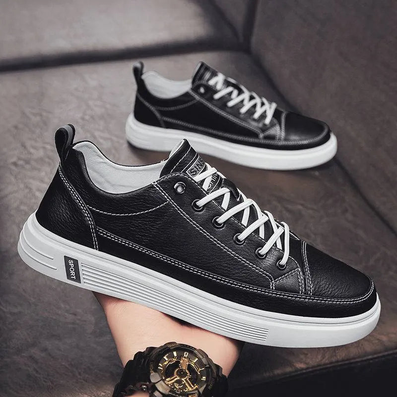 Men's white casual flat shoes with round toe and low heel on a plain background.