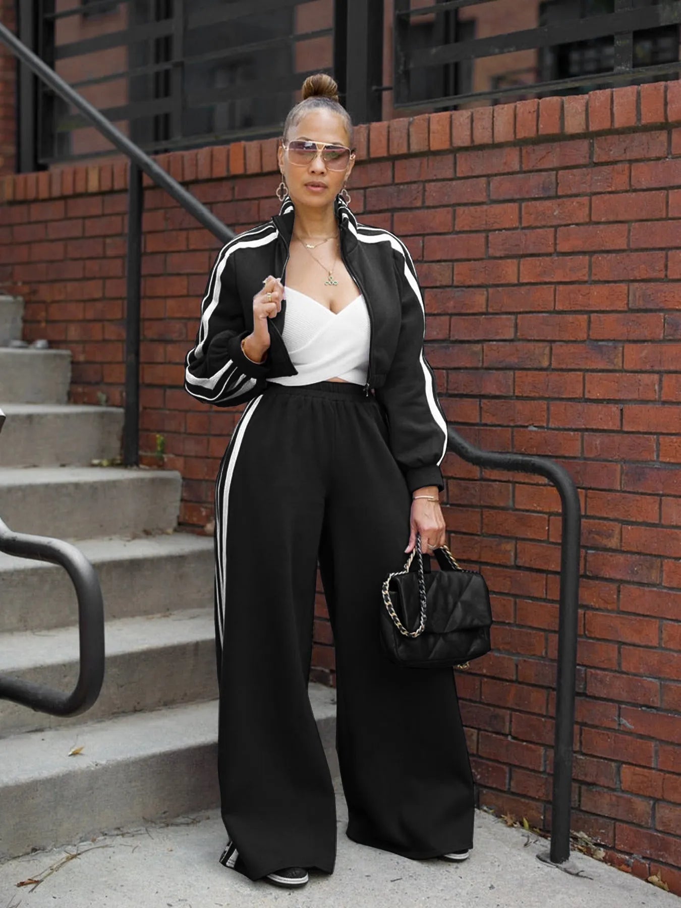 Grey striped streetwear two-piece set featuring a sweater with regular sleeves and matching trousers.