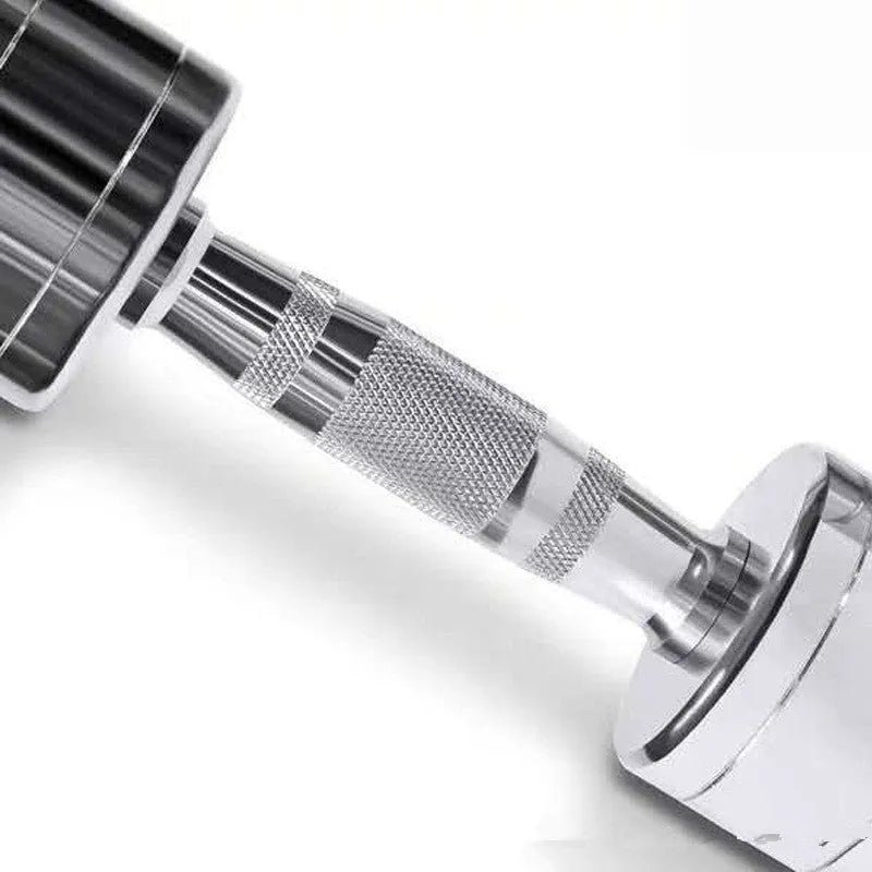 Silver electroplated steel dumbbell with hexagonal handle on a gym floor