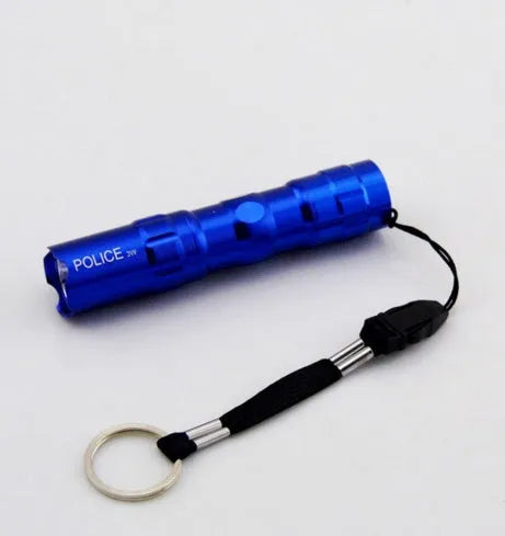 Black aluminium alloy mini LED handheld flashlight next to a AA battery