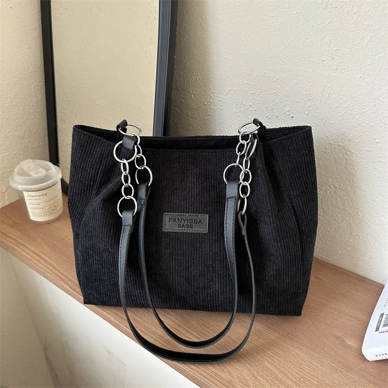 Corduroy one-shoulder tote handbag in a horizontal square shape, shown in brown colour.