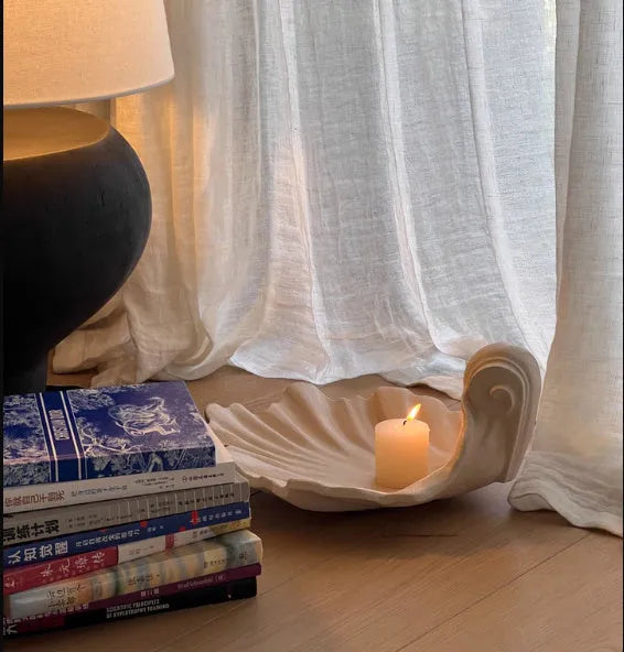 White resin simulation shell fruit plate ornament on a table