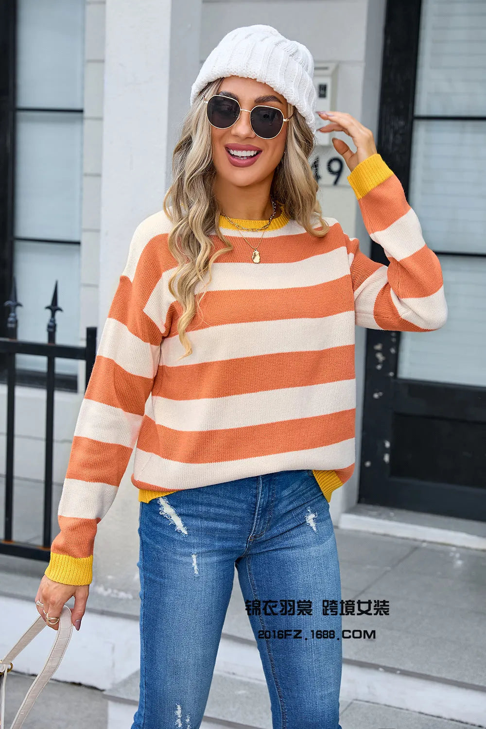 Women's loose blue acrylic long sleeve sweater with round neck on hanger