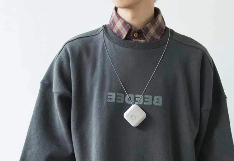Mini USB air purifier necklace in pink showing compact wearable design with one-button control