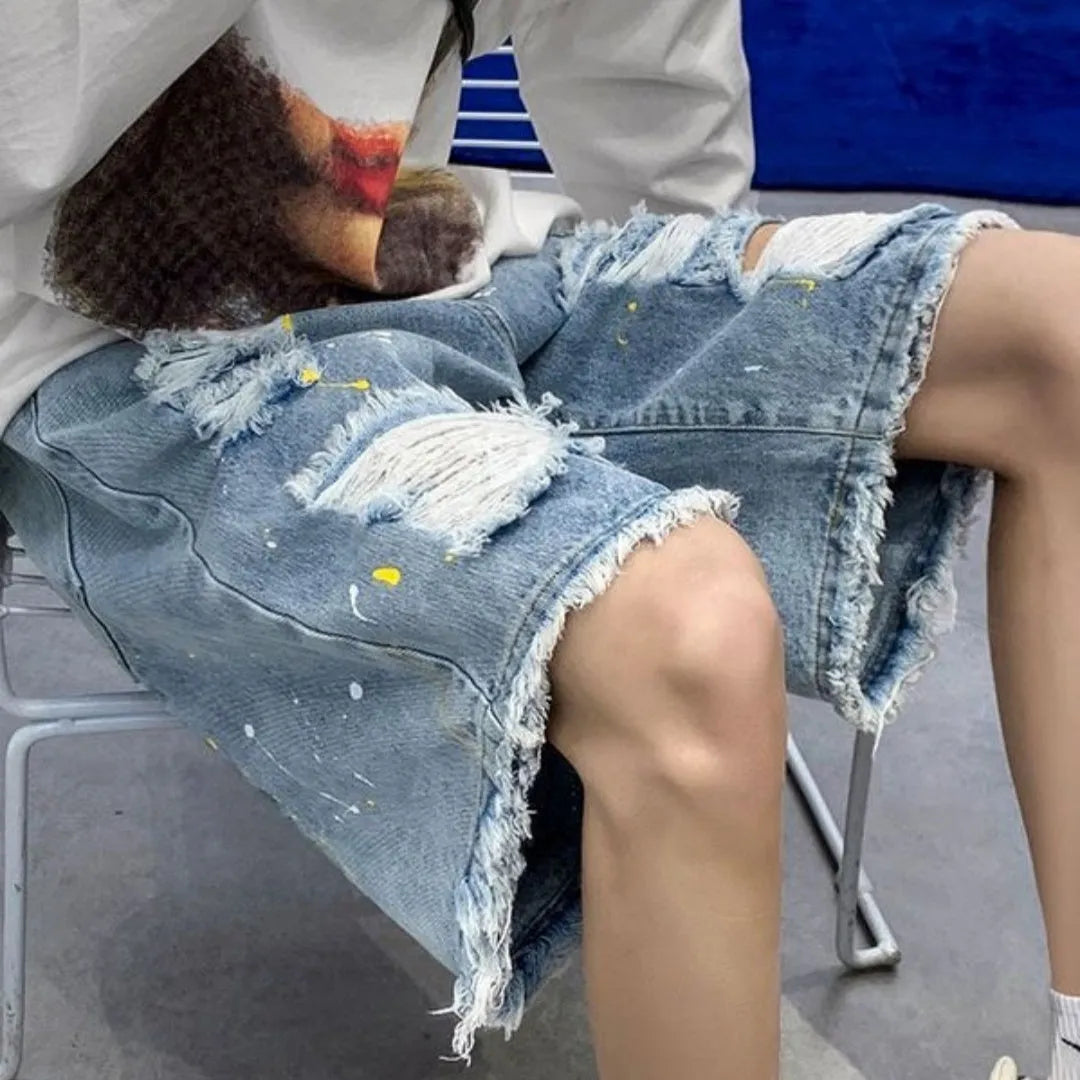Men's loose fit light blue water washed denim shorts on a hanger.