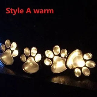 Black solar powered animal paw print LED garden lights set of four with solar panel pole