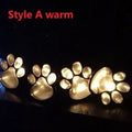 Black solar powered animal paw print LED garden lights set of four with solar panel pole