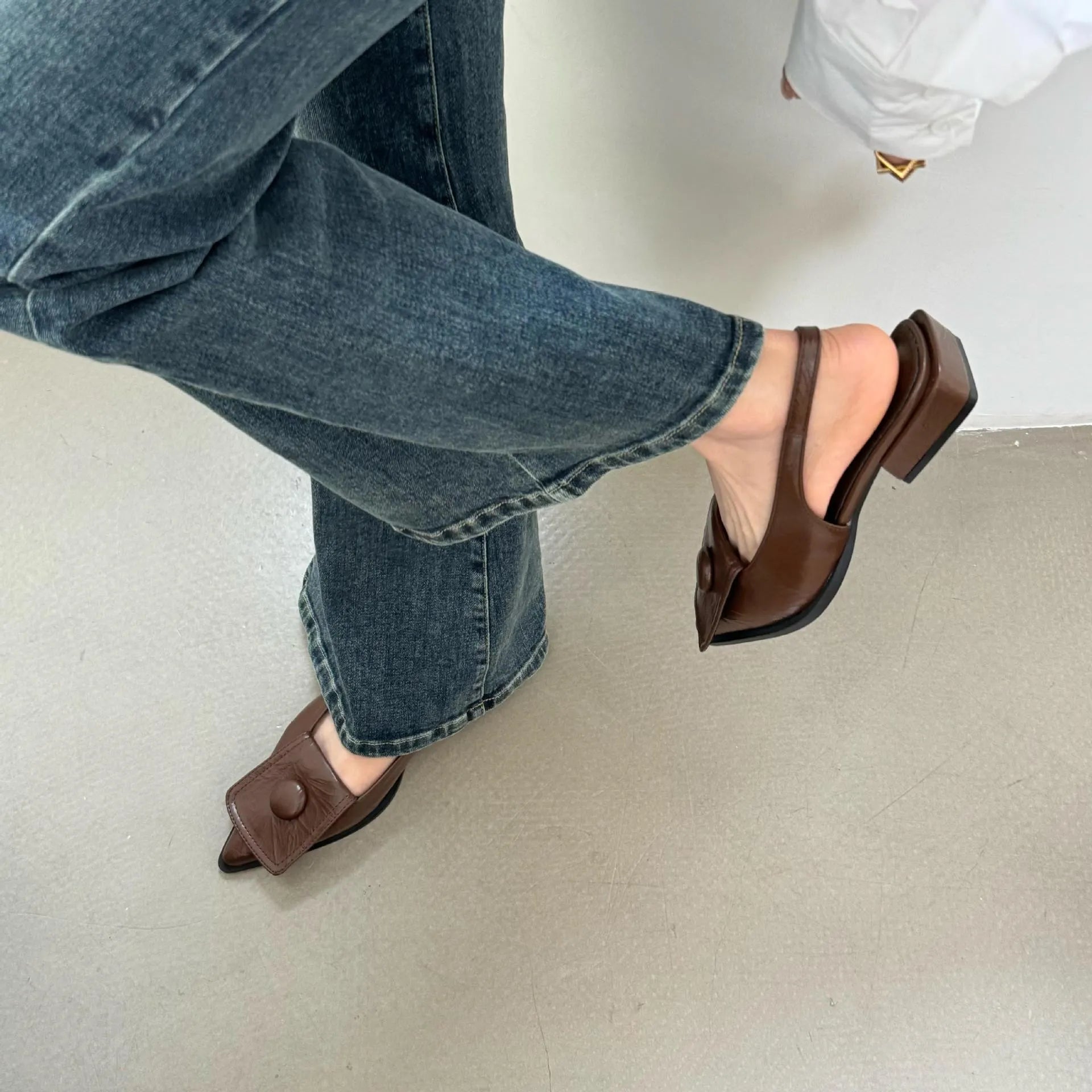Women's pointed toe low heel sandals with back strap in apricot colour.