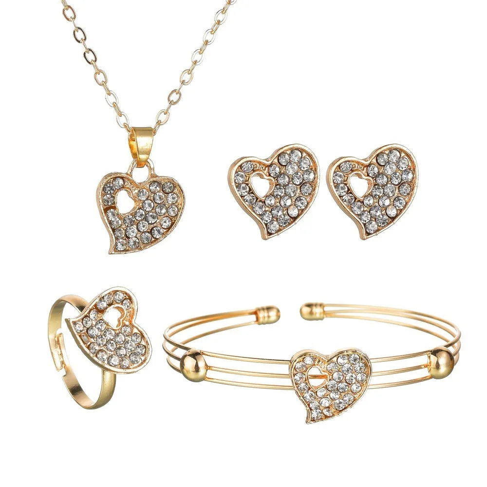 Gold jewellery set with earrings, pendant and adjustable bracelet showing love, water drop and bell motifs