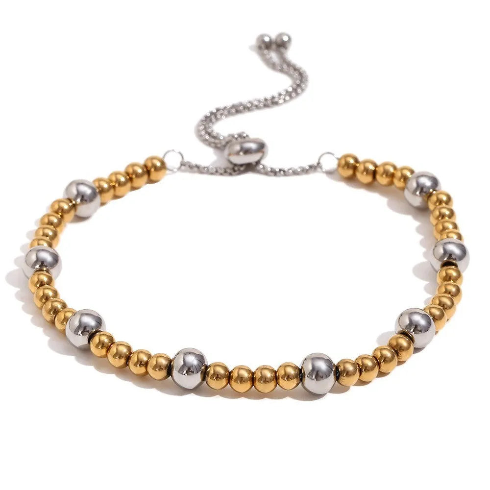 Gold tone geometric jewellery set including earrings, bracelet and necklace with round ring design elements