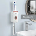 Automatic wall-mounted toothpaste dispenser in blue, grey, and pink colours with USB charging cable.