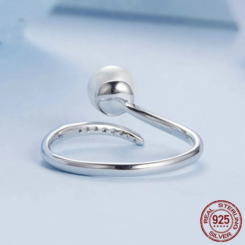 Sterling silver adjustable pearl ring with natural shell pearls on open loop design