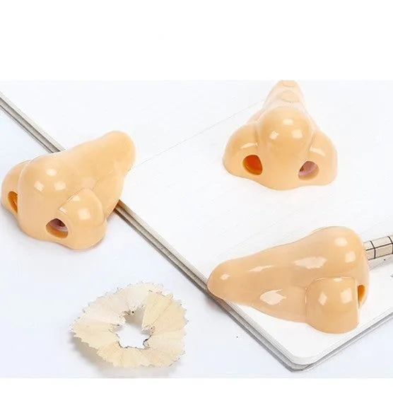 Flesh colour plastic pencil sharpener with geometry shape measuring 58x45x30 mm