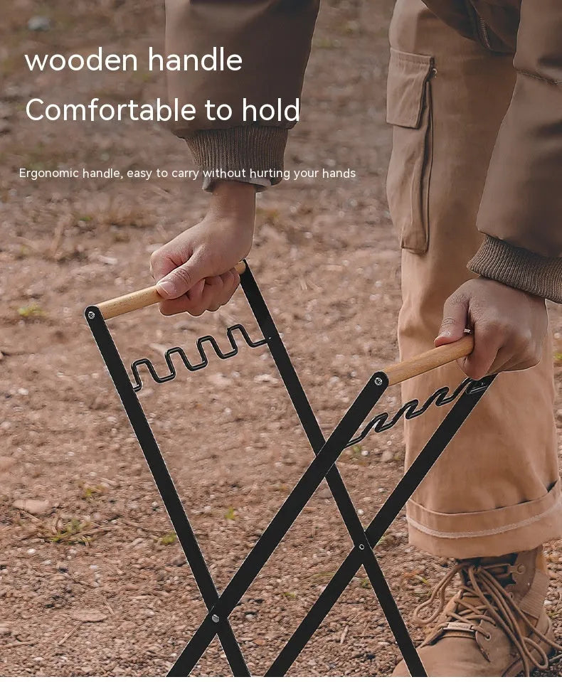 Black folding iron outdoor trash rack with a wooden handle standing upright.
