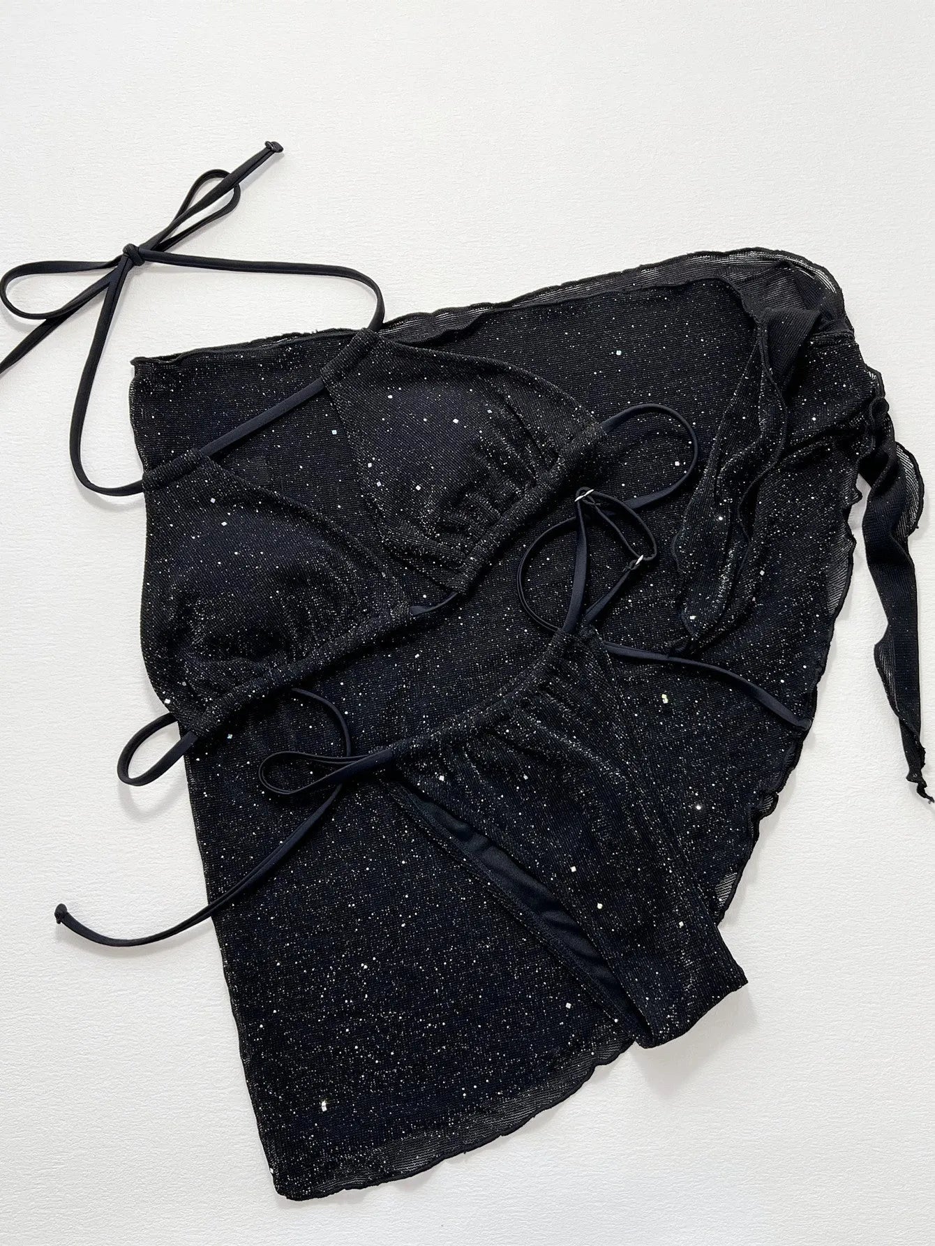 Black three-piece bikini swimsuit set with crop top and shorts on a mannequin.
