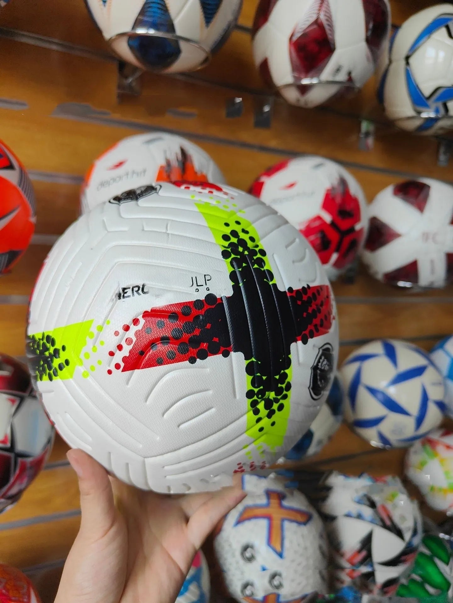 Fluorescent green size 5 PU football on a sports field