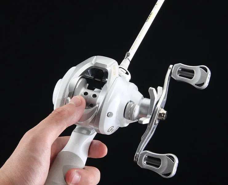 Small white ET Drop Wheel bait casting fishing reel on a neutral background.