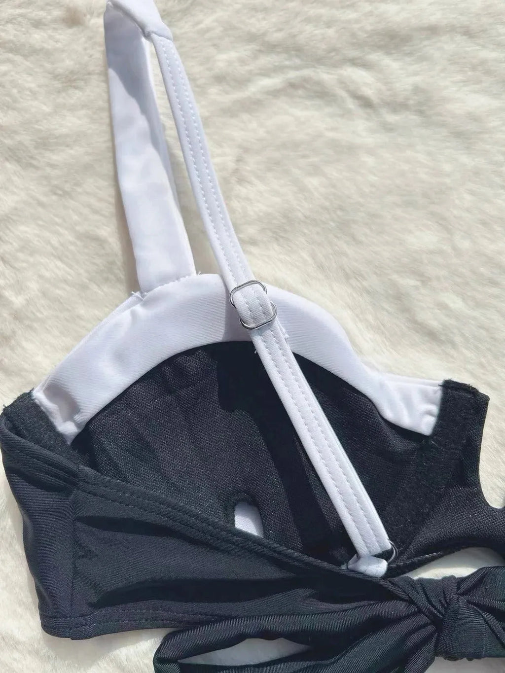 Black low waist women's bikini swimsuit with stitching split detail on briefs.