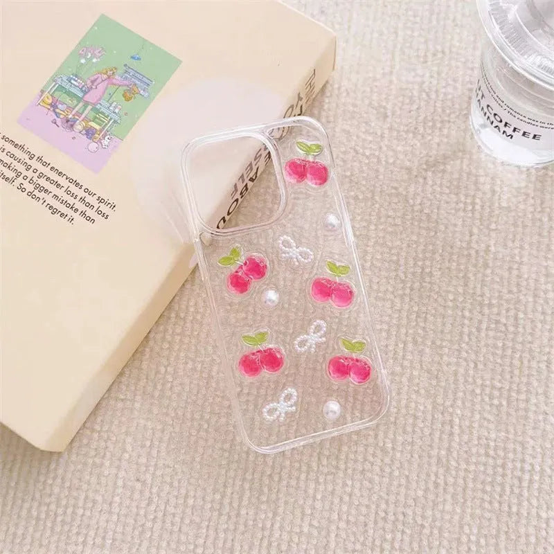 Epoxy three-dimensional cherry bow phone case in transparent finish showing decorative cherry and bow design on front