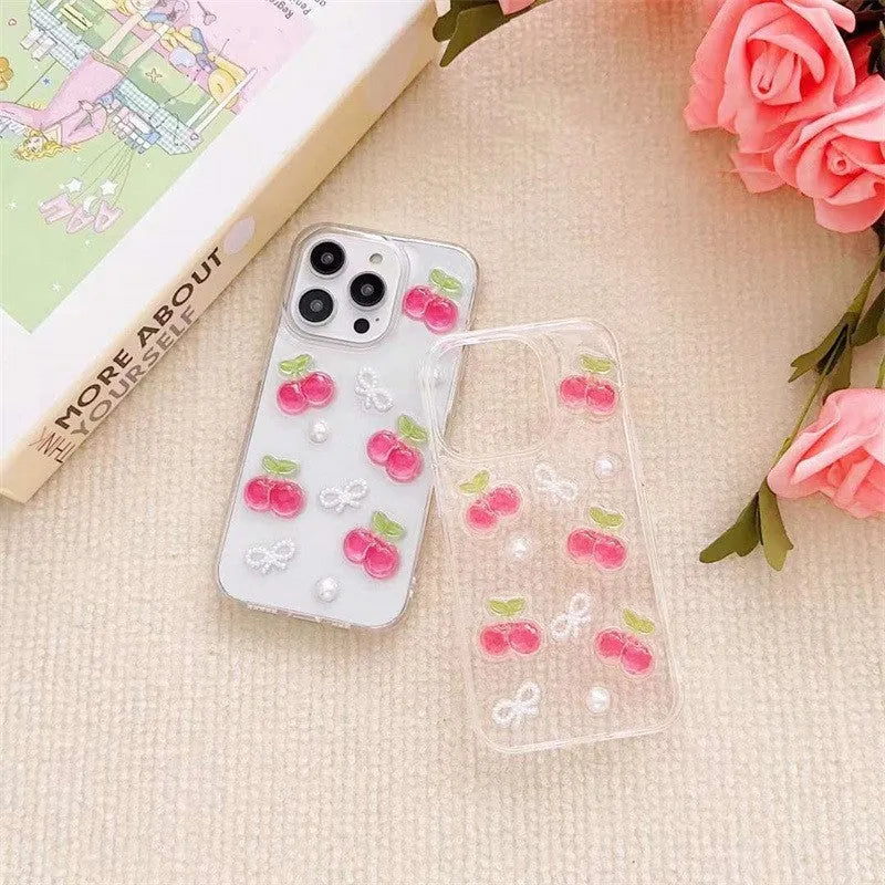 Epoxy three-dimensional cherry bow phone case in transparent finish showing decorative cherry and bow design on front