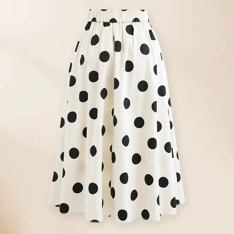 Women's black one-piece swimsuit with attached beach dress featuring a round skirt and bow detail.