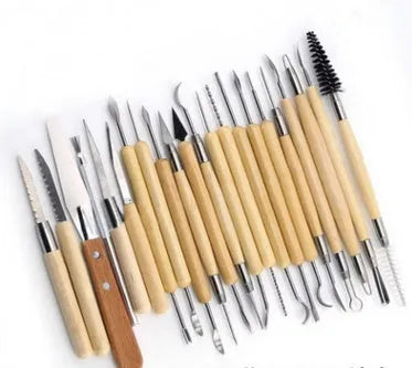 27-piece pottery tool set with roller, featuring wood, stainless steel, and plastic sculpting tools on a table.