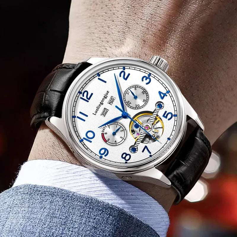 Men's stainless steel business watch with leather strap and sapphire glass, showing transparent case back.