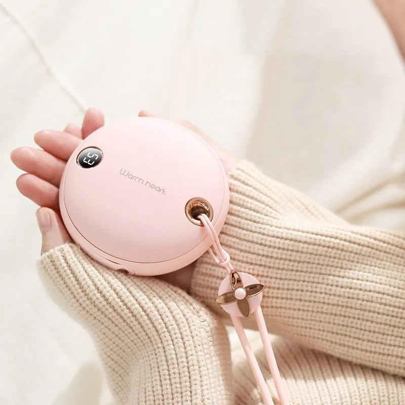 Green hand warmer power bank with digital display showing 5000mAh capacity and heating function