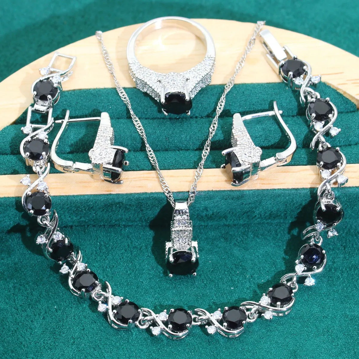 Four-piece bridal jewellery set showing necklace, earrings, ring, and bracelet with alloy pendant and water wave chain