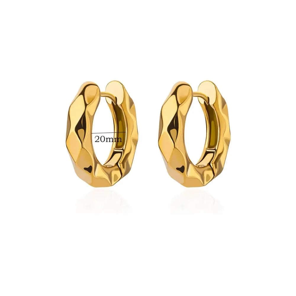 Geometric butterfly-shaped earrings with heart, bow, and star details in copper with a diamond-cut finish.