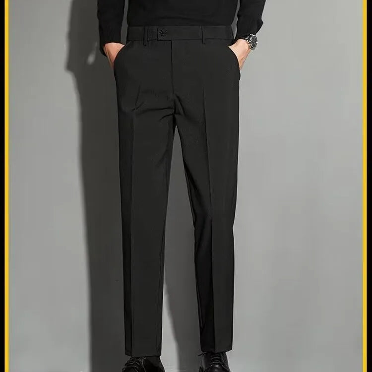 Man wearing straight-leg suit trousers with an ankle-length draping effect in a light colour.