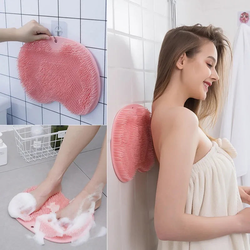 Orange silicone bath massage brush mat with suction cups on a bathroom floor