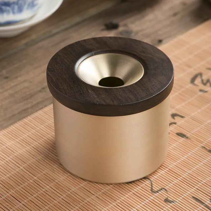 Brass ashtray with a wooden lid featuring a central hole, shown in black wood and red wood options.