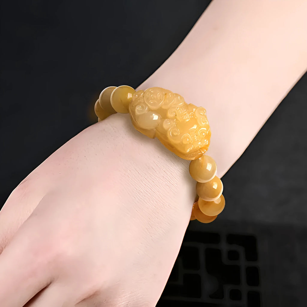 Hand-carved Jinsi Jade money bracelet showing golden thread patterns, displayed in large and small size options.