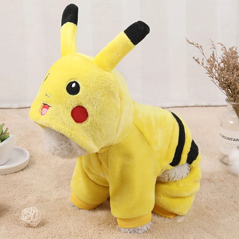 A small dog or cat wearing a cartoon-design fleece coat with a hoodie, suitable for indoor winter wear.