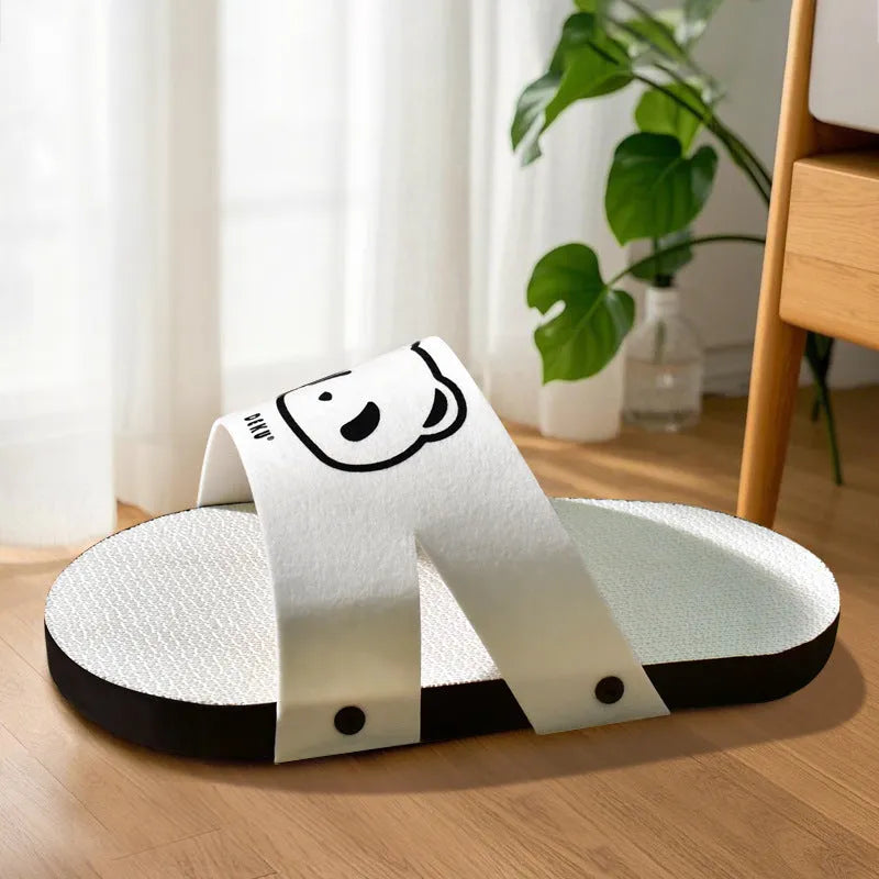 White slipper-style corrugated paper cat scratch board on flat surface