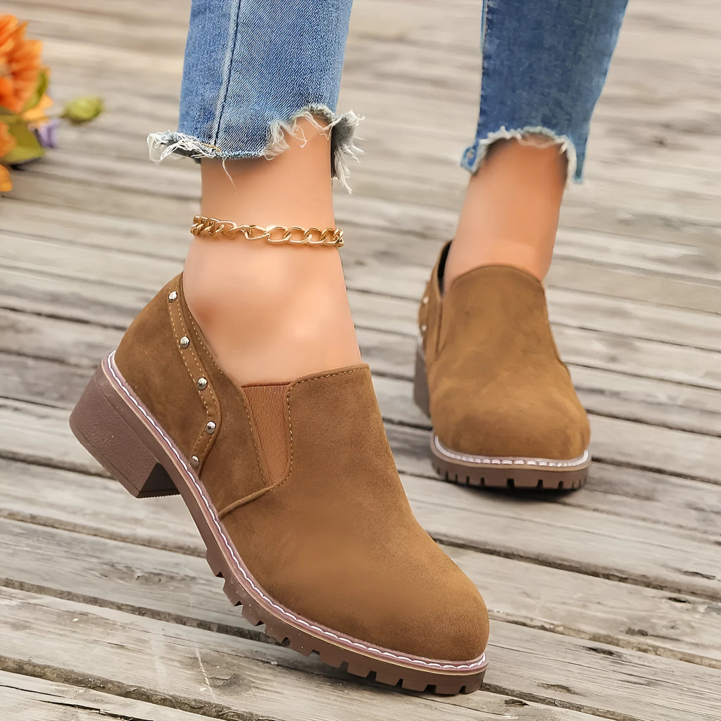 Women's light brown suede ankle boots with a thick low heel and elastic band fastening.