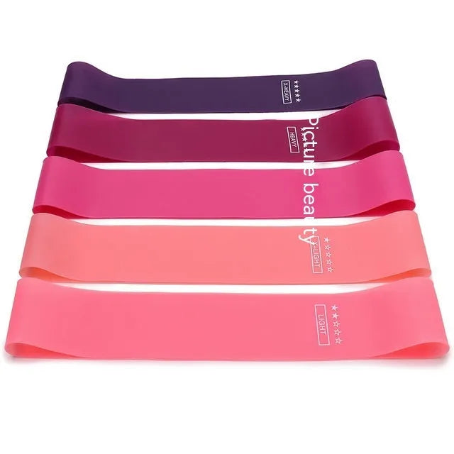 Five colour-coded TPE yoga tension straps with graduated thickness for resistance training