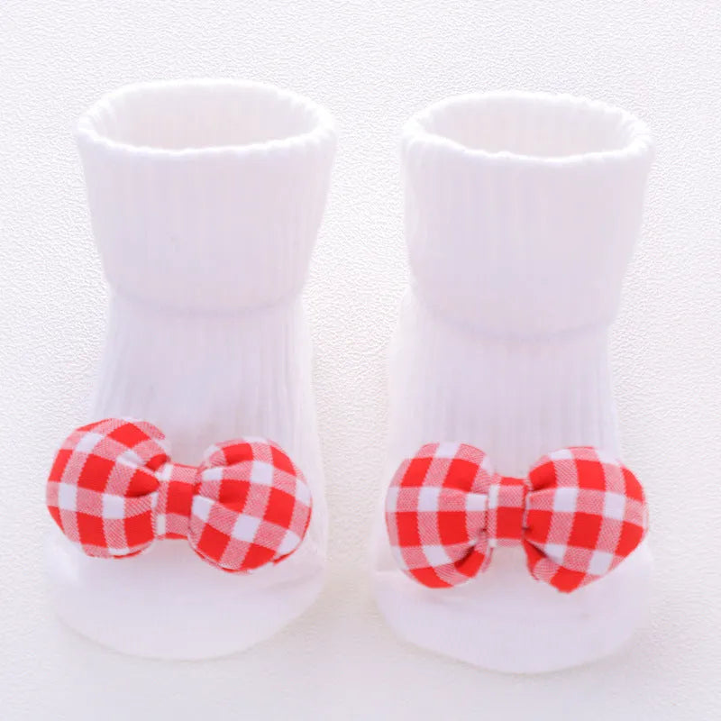 Cotton baby floor socks in various patterns including animal prints, stars, and bows for infants aged 0-3 months