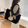 Plush shoulder bag with cartoon rabbit ears detail in solid colour