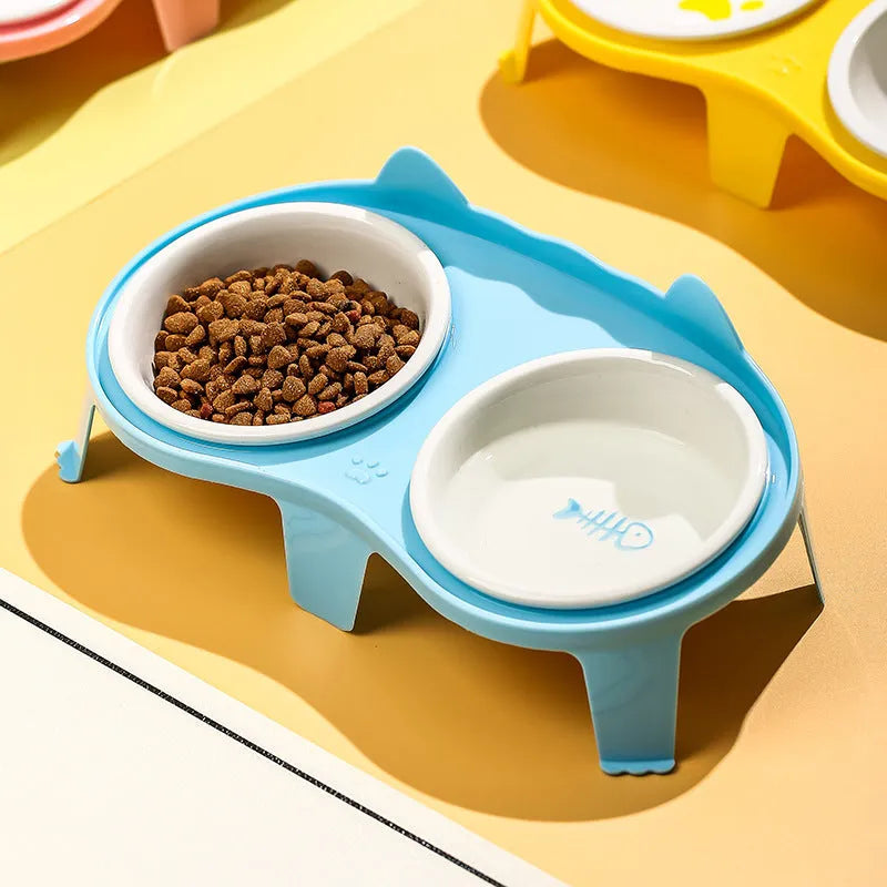 Blue ceramic cat food and water bowls in an elevated white ABS plastic stand with a hook