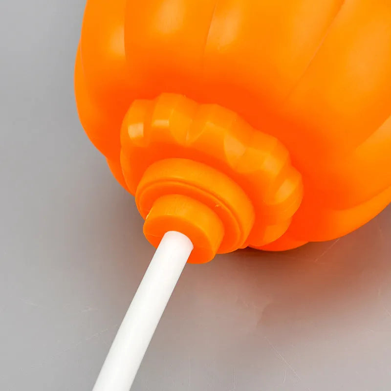Plastic pumpkin-shaped decorative lamp with USB cable, showing purple or yellow light option.