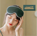 Pink or green portable eye SPA massage goggles on a grey background