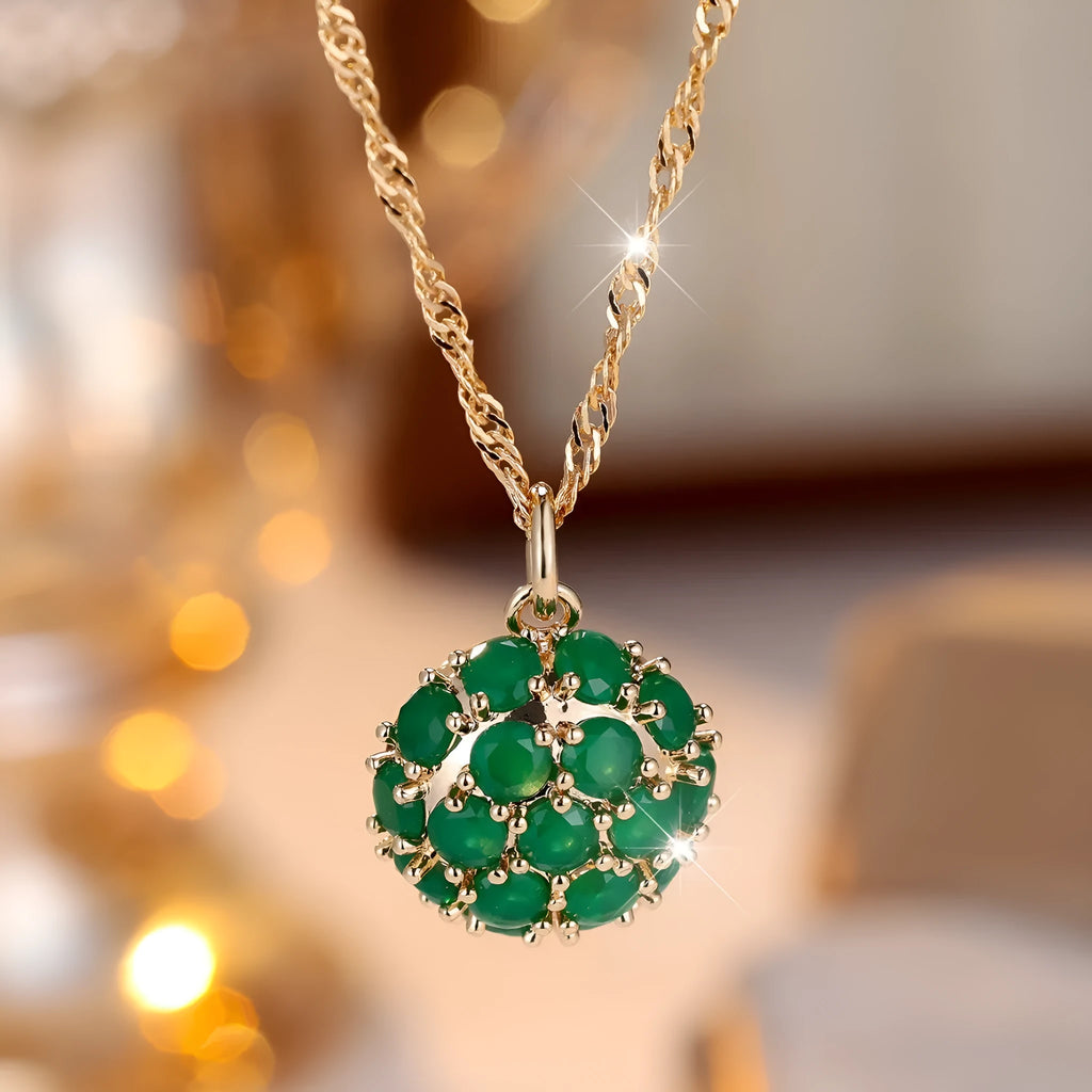 Round emerald pendant necklace with full diamond detailing in champagne gold colour on chain